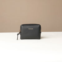 front view of a black Danilos leather toilet mini emma pouch on a beige background