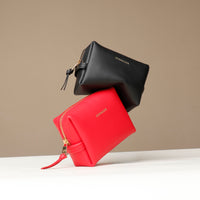 Black and red leather mini emma toilet danilos leather pouches with gold zipper on a beige background