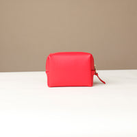 back view of a Red cosmetic bag mini emma danilos leather on a beige background
