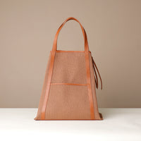 Angled view of Tosca Isola mesh tote bag with leather straps