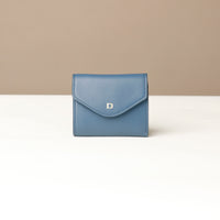 Blue wallet with a brand logo on a beige background
