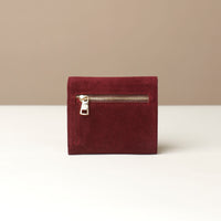 Red suede leather danilos wallet with a zipper on a beige background