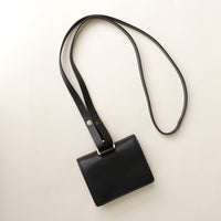 Styled angled shot of Olivia wallet crossbody on neutral background