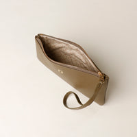Beige handbag with a strap on a light beige background